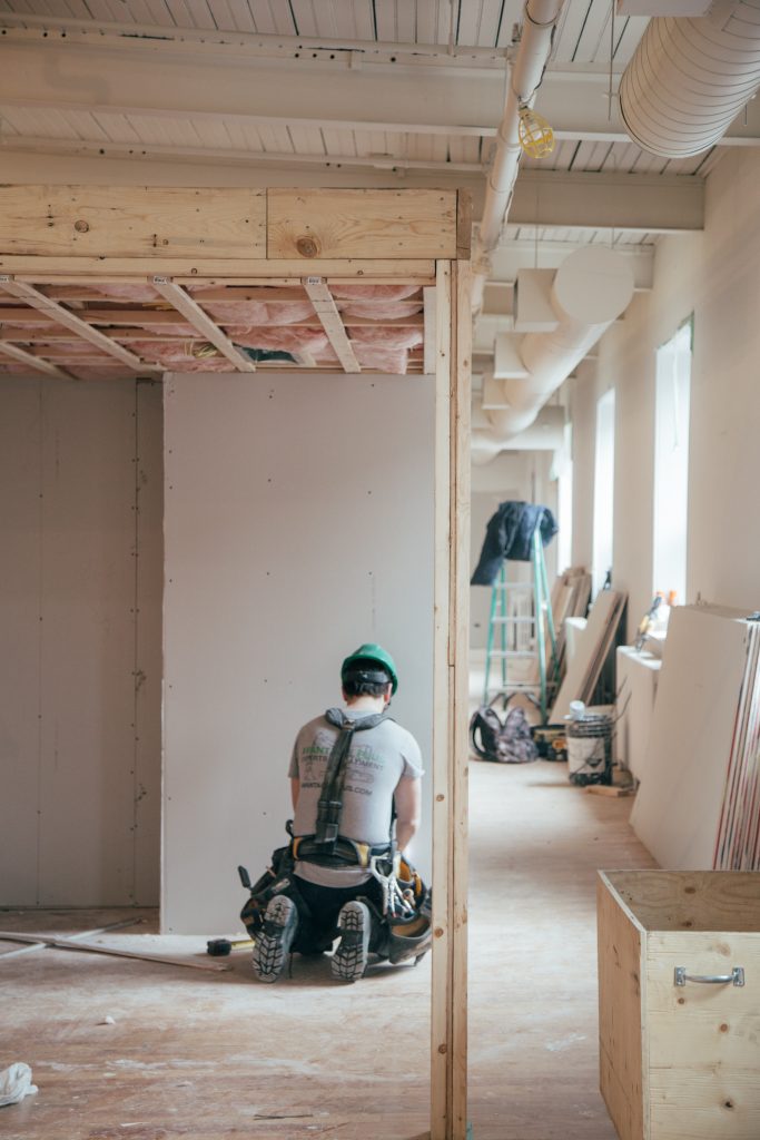 man kneeling in front of wall